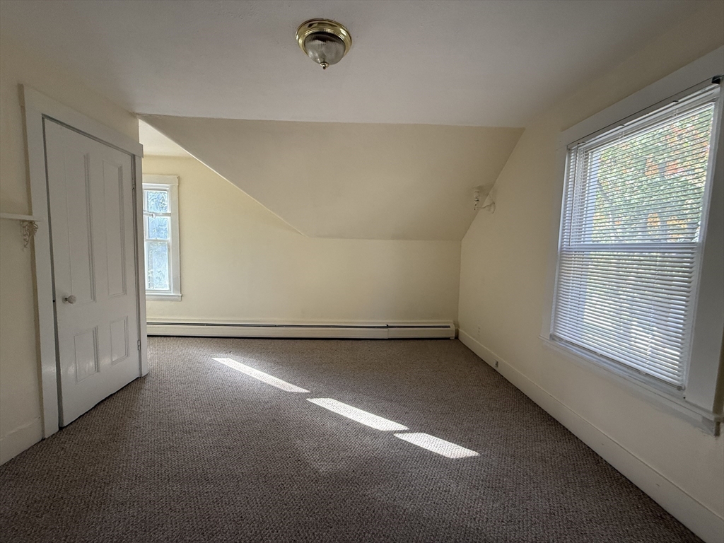 314 Webster Street, Unit B Needham, MA 02494 - Photo 11 of 14 an empty room with a empty space and windows