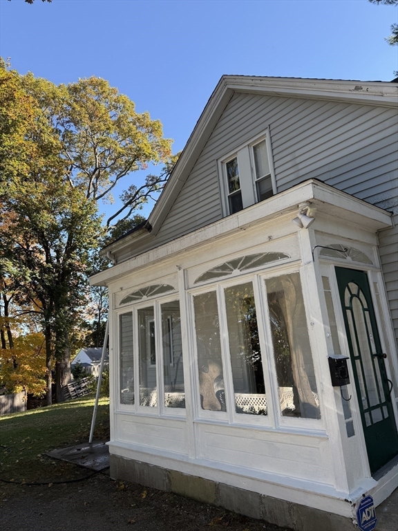 314 Webster Street, Unit B Needham, MA 02494 - Photo 3 of 14 a view of a house with a small yard and wooden fence
