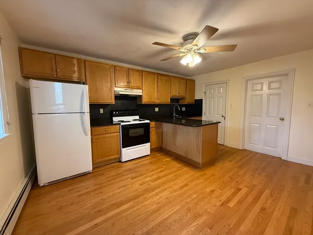 a kitchen with kitchen island a sink stainless steel appliances and cabinets