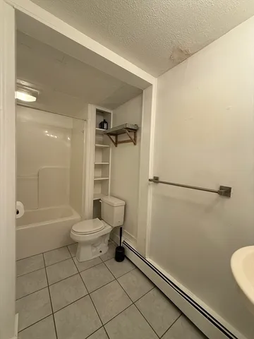 a bathroom with a toilet a sink and shower