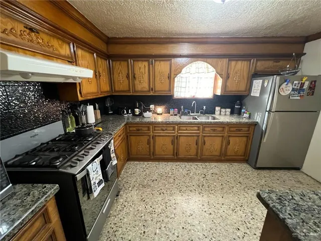 a kitchen with lots of counter top space sink and stove