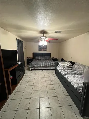 a bedroom with a bed and a television