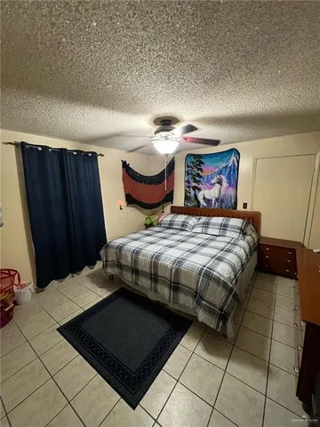 a bedroom with a bed and a mirror