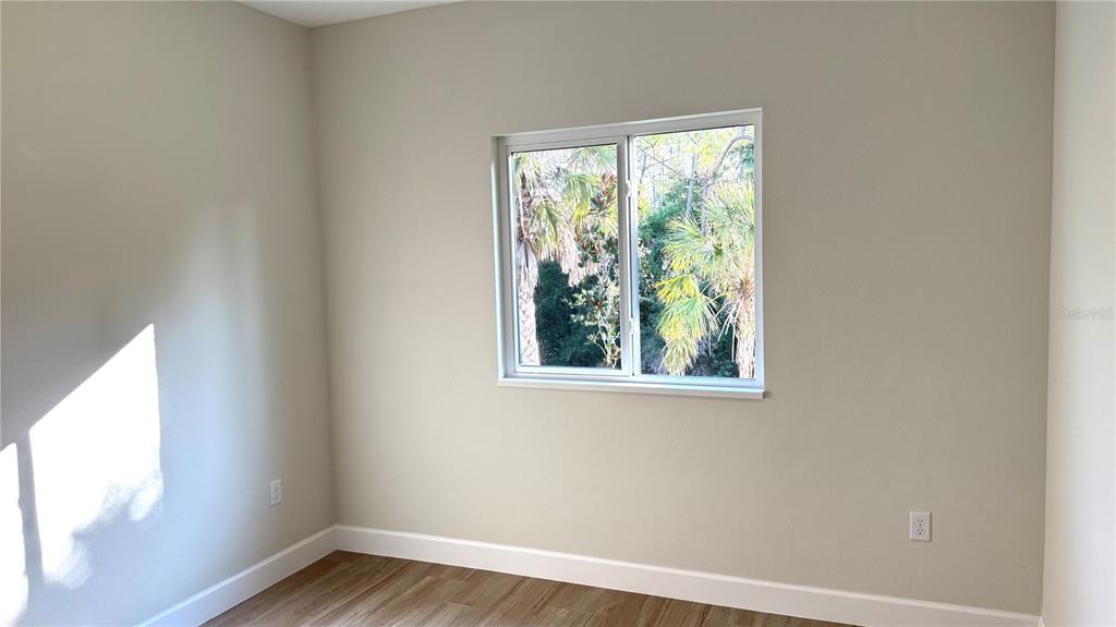 4884 Kisla Rd Port North Port, FL 34288 - Photo 12 of 19 a view of an empty room with wooden floor and a window
