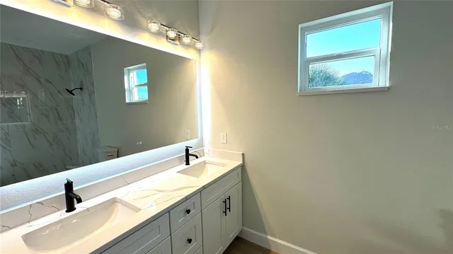 a bathroom with a sink and a mirror