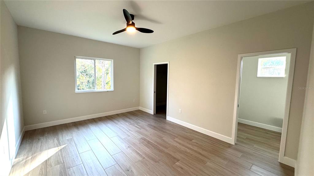 4884 Kisla Rd Port North Port, FL 34288 - Photo 7 of 19 a view of an empty room with wooden floor and a window