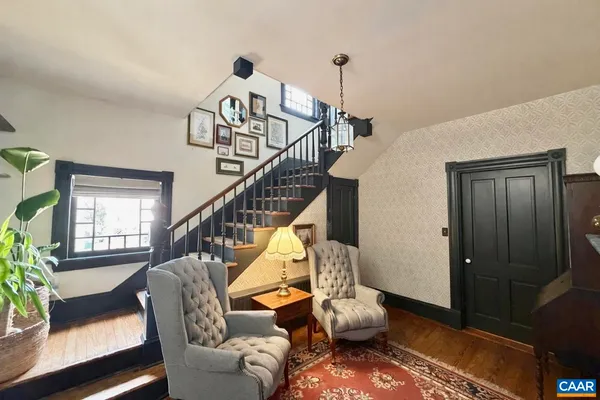 a view of entryway and hall with wooden floor