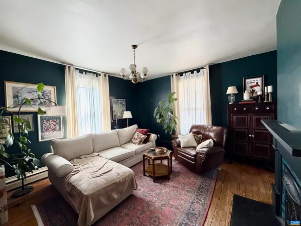 a living room with furniture flat screen tv and a large window