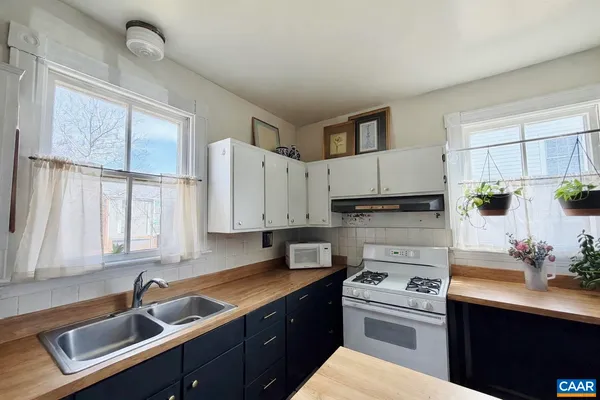 a kitchen that has a sink and a stove in it