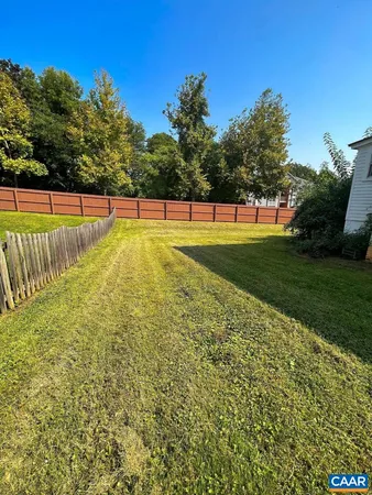 a view of a swimming pool with a yard