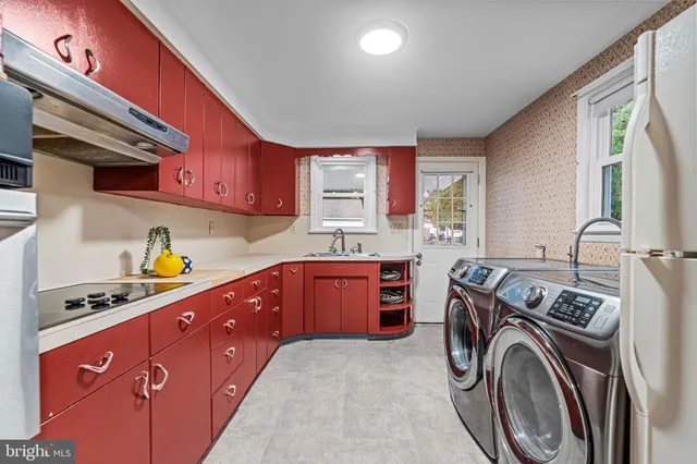a kitchen with stainless steel appliances granite countertop a stove sink and cabinets