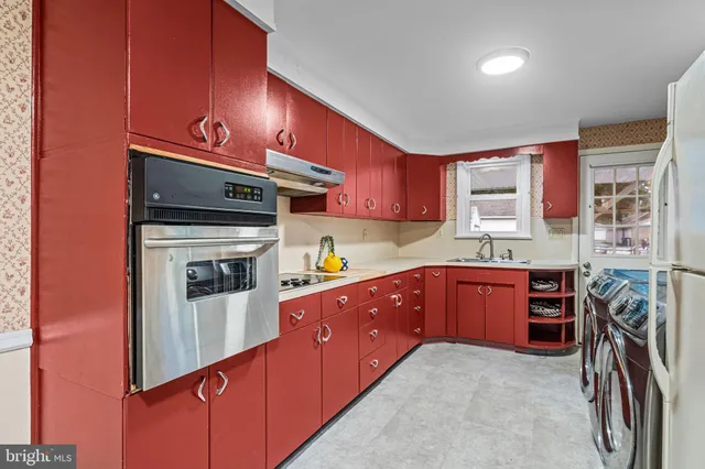 a kitchen with stainless steel appliances granite countertop a sink stove and cabinets