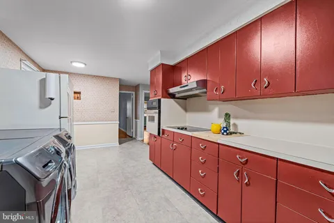 a utility room with sink dryer and washer