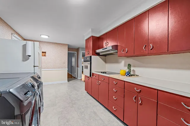a utility room with sink dryer and washer
