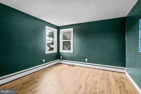 an empty room with wooden floor and closet