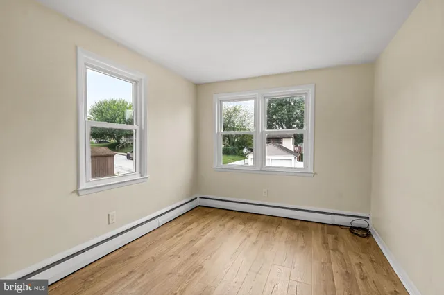 a view of a kitchen with wooden floor and a refrigerator