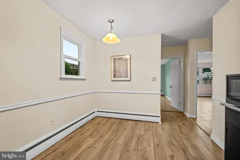 a kitchen with stainless steel appliances a refrigerator and a wooden floor