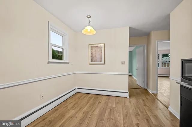 a kitchen with stainless steel appliances a refrigerator and a wooden floor