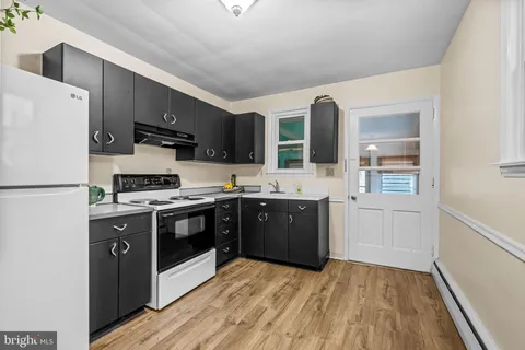 a kitchen with stainless steel appliances a refrigerator stove and sink
