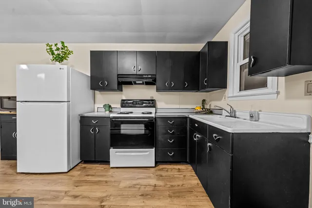 a kitchen with a stove and a refrigerator