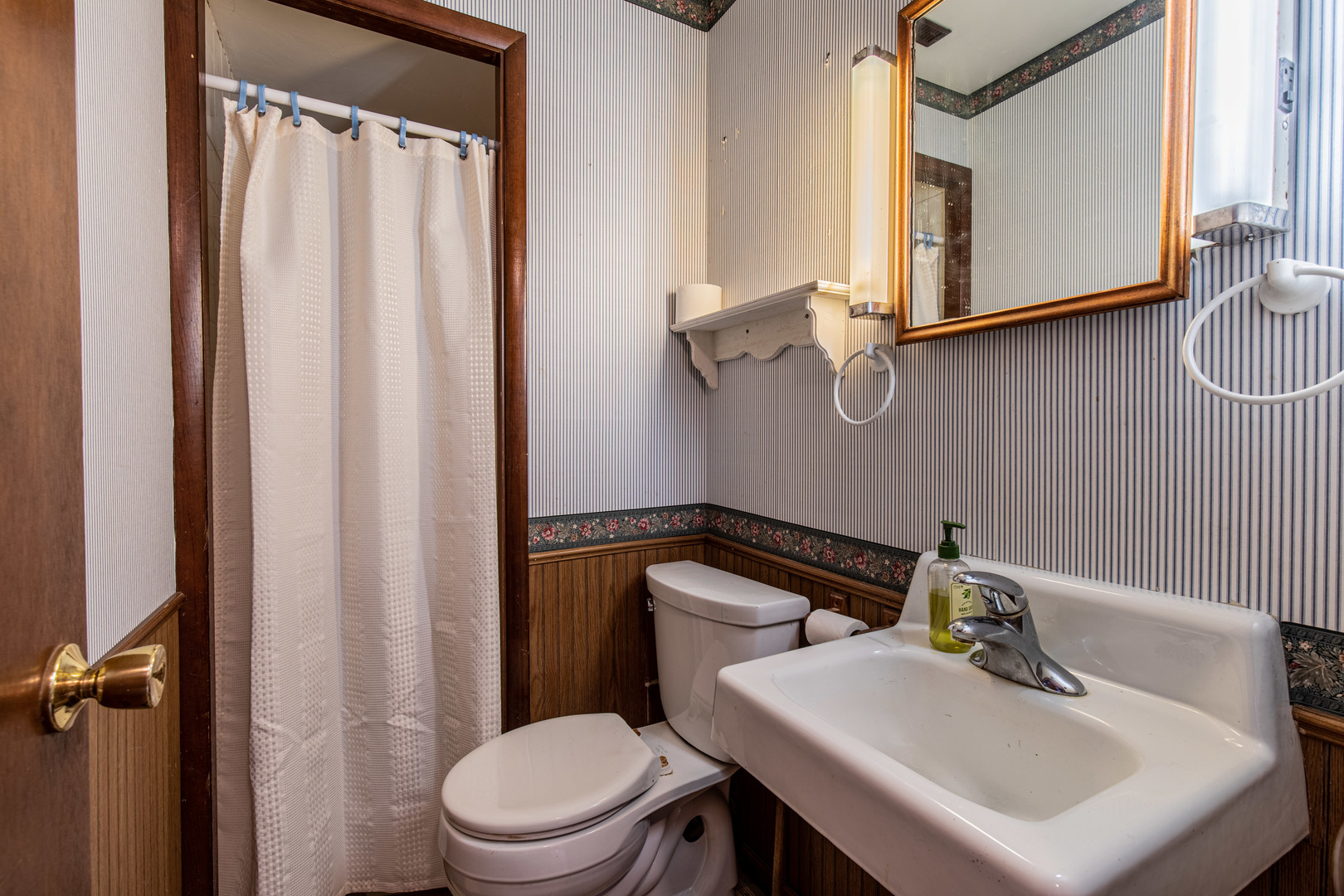 405 Depot Street Walnut, IL 61376 - Photo 17 of 20 a bathroom with a sink a toilet and mirror