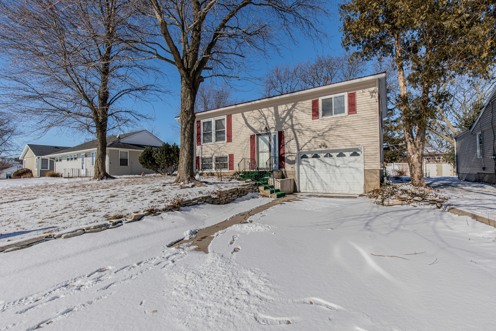 405 Depot Street Walnut, IL 61376 - Photo 3 of 20 a front view of a house with a yard covered in snow