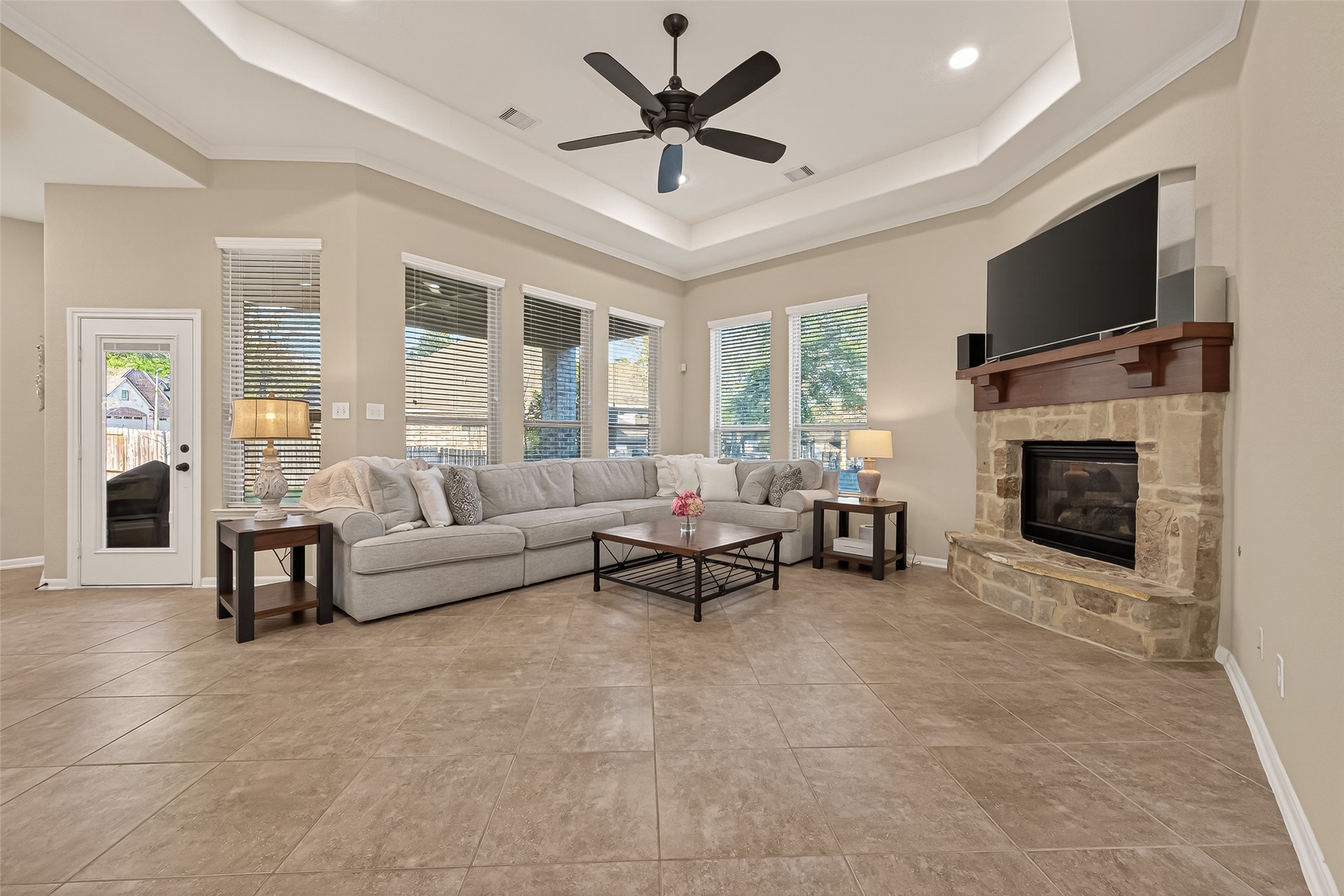 10 Ruchill Circle Conroe, TX 77304 - Photo 11 of 47 Wow to this Living Room. 2 walls of windows, for natural lighting, coffer ceilings, and a fireplace. Home sweet home!