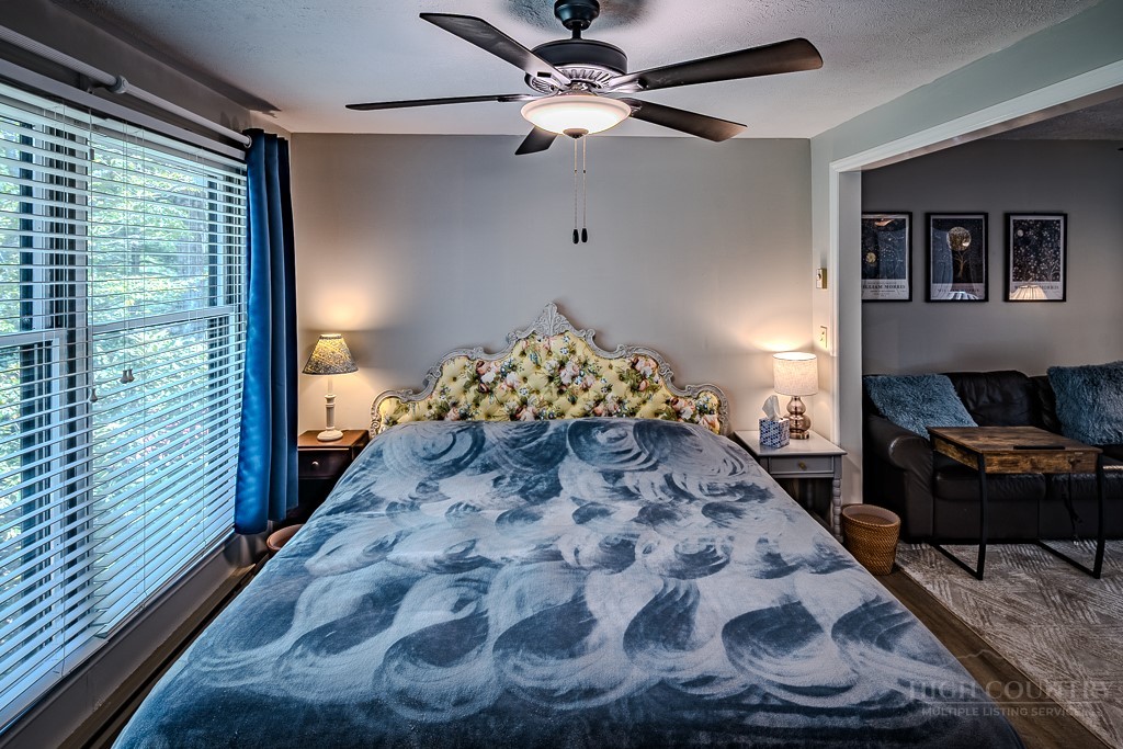 38 Rocky Meadows Road Newland, NC 28657 - Photo 19 of 50 a living room with a bed and a chandelier