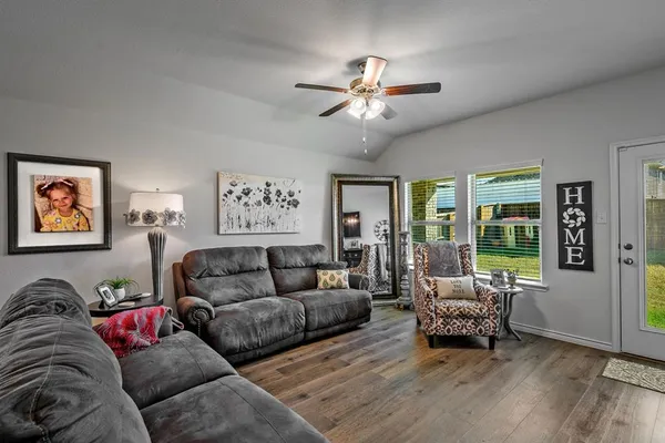 a kitchen that has a lot of cabinets a stove and a bookshelf