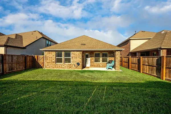 a bathroom with a refrigerator and a wooden floor