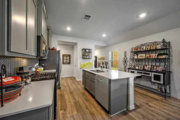 a kitchen with stainless steel appliances a refrigerator sink and stove