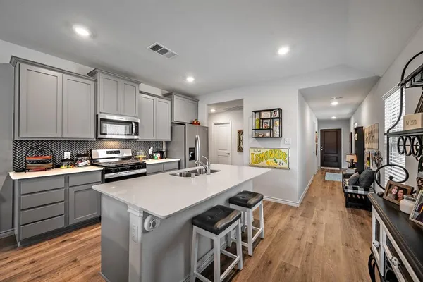 a kitchen with stainless steel appliances granite countertop a stove oven and a refrigerator