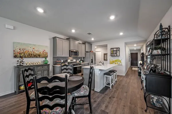 a kitchen with a sink a stove cabinets and appliances