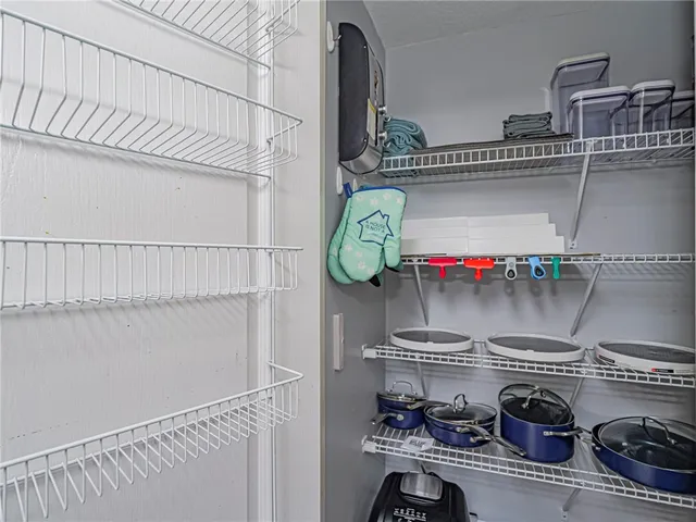 a kitchen with cabinets appliances a sink and a counter top