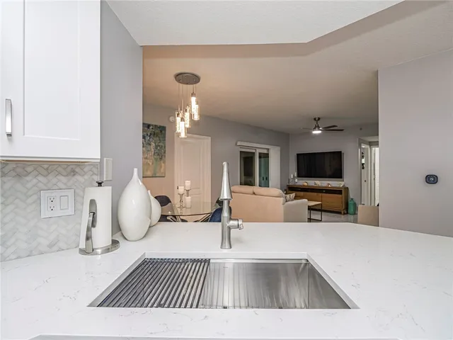 a view of a dining room with furniture and chandelier