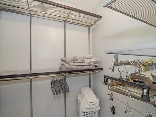 a bedroom with a large bed and a large window