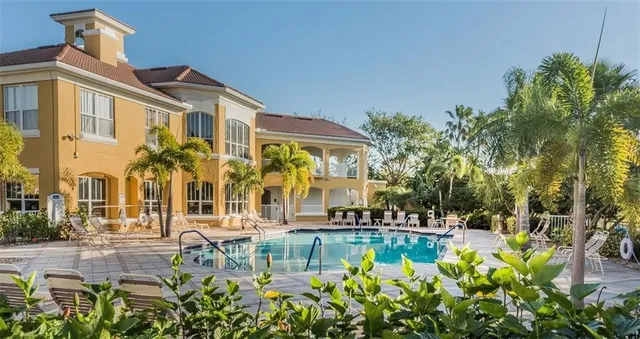 a front view of a house with swimming pool and patio