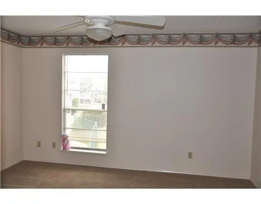 a view of a room with rack on the wall and a window