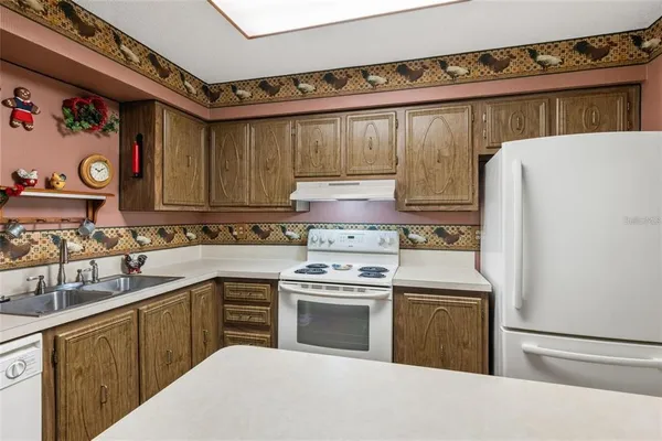 a kitchen with a stove a sink and a refrigerator