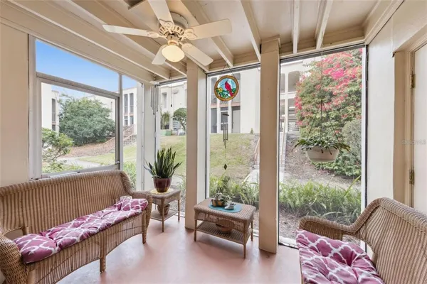 a living room with furniture and a floor to ceiling window