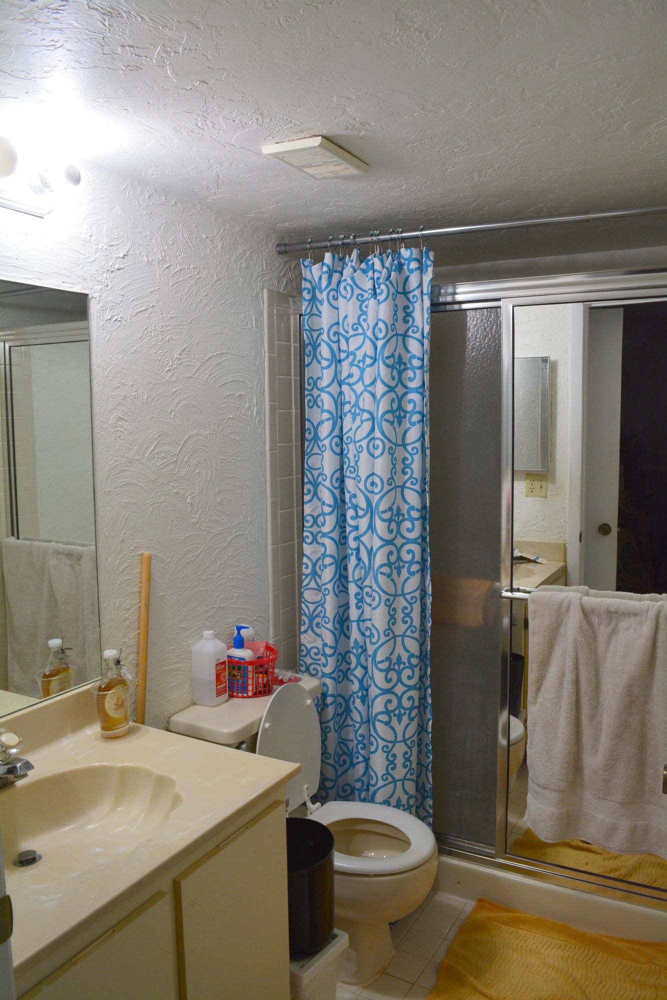 9480 Boca Cove Circle, Unit 405 Boca Raton, FL 33428 - Photo 12 of 12 a bathroom with a sink toilet and shower