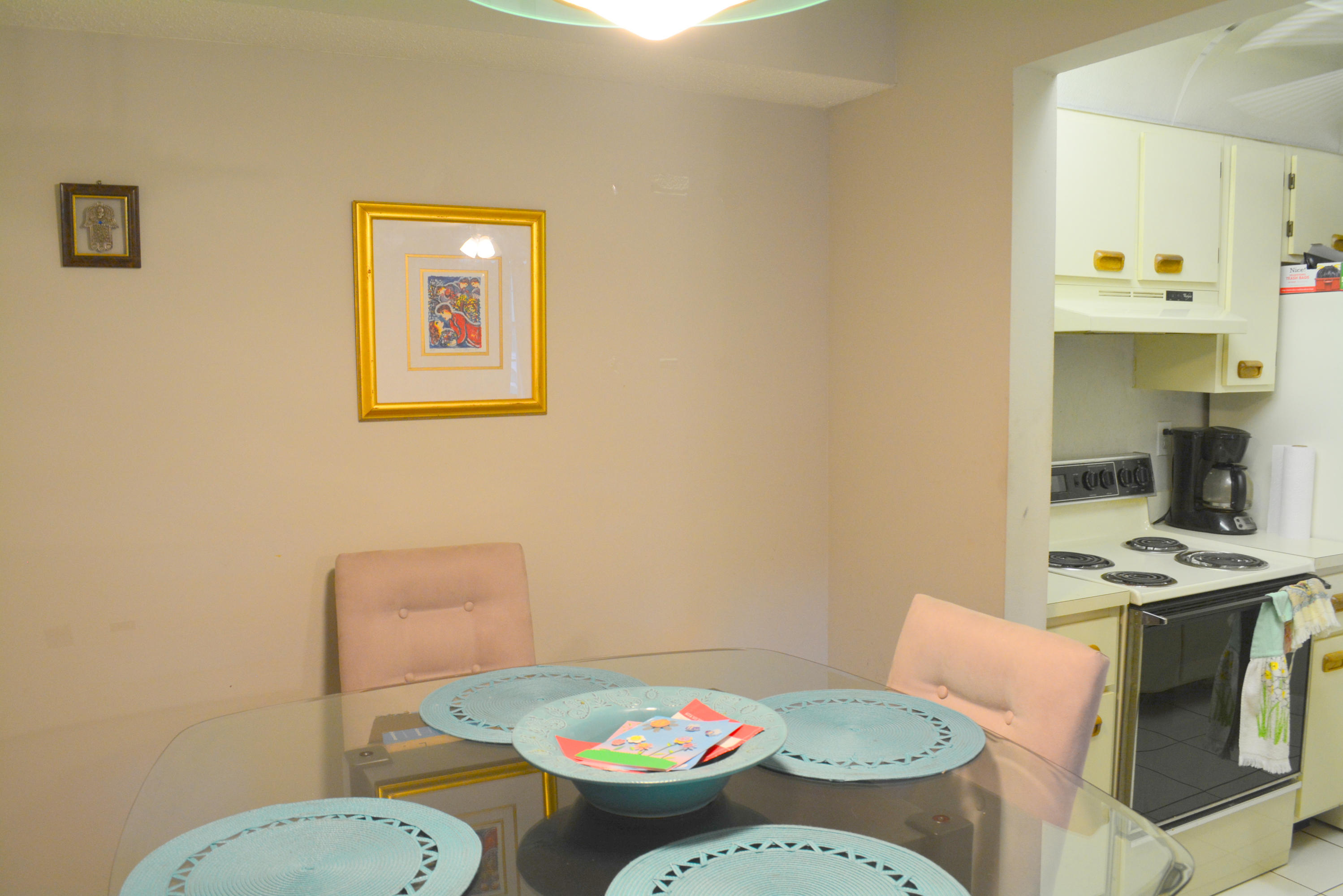9480 Boca Cove Circle, Unit 405 Boca Raton, FL 33428 - Photo 7 of 12 a view of a dining room with furniture