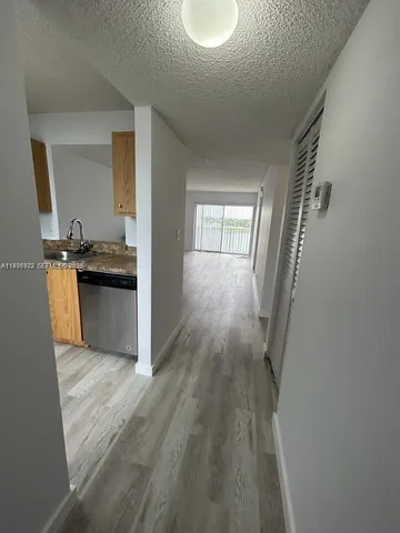 a view of a kitchen from the hallway