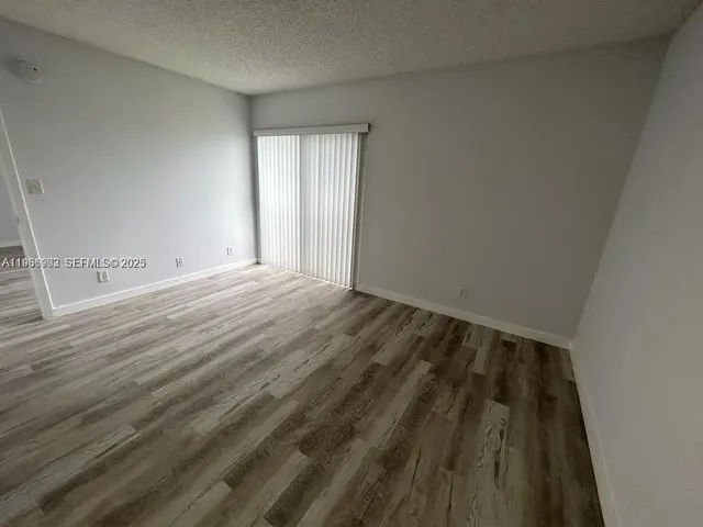 a view of an empty room and wooden floor