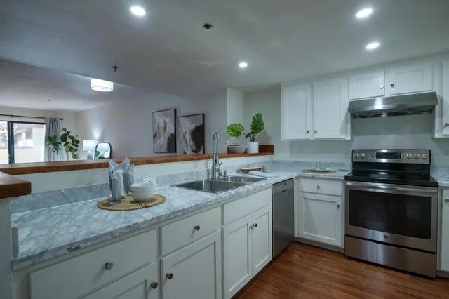 a kitchen with a sink stove and refrigerator