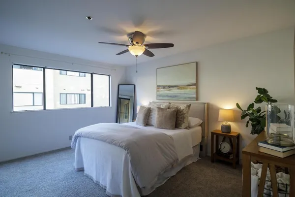a bedroom with a bed and a chandelier