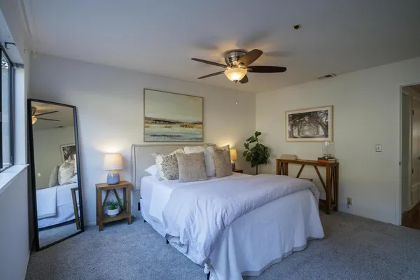 a bedroom with a bed and a chandelier