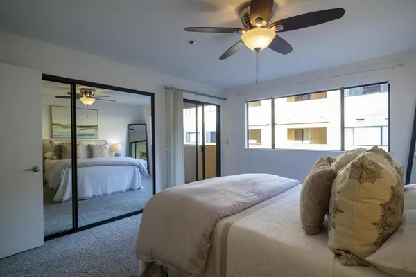 a bedroom with a bed and a chandelier