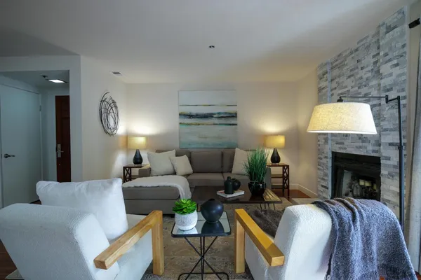 a living room with furniture and a fireplace