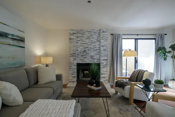 a living room with furniture and a fireplace